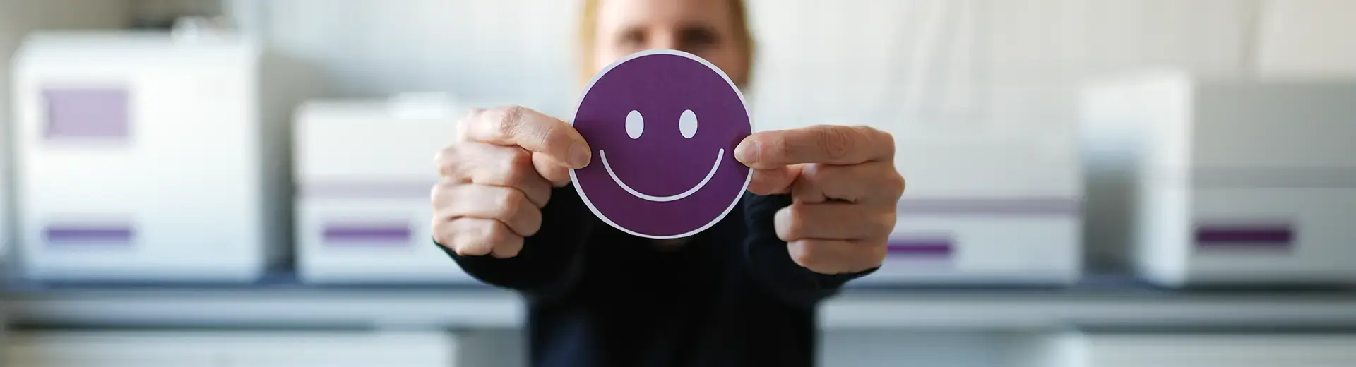 A scientist holding up a smiling smiley face